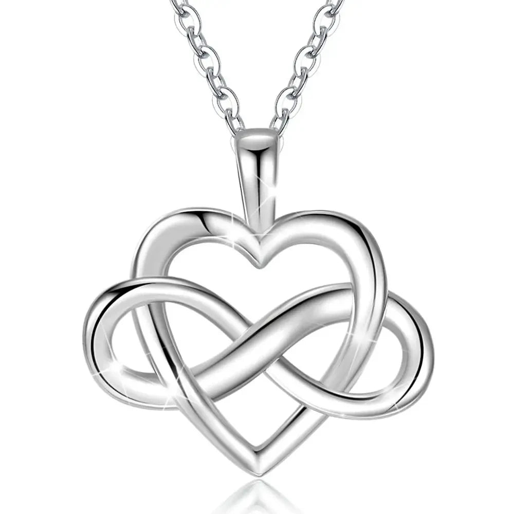 Polished infinity heart necklace with an open heart and woven loop suspended from a linked chain