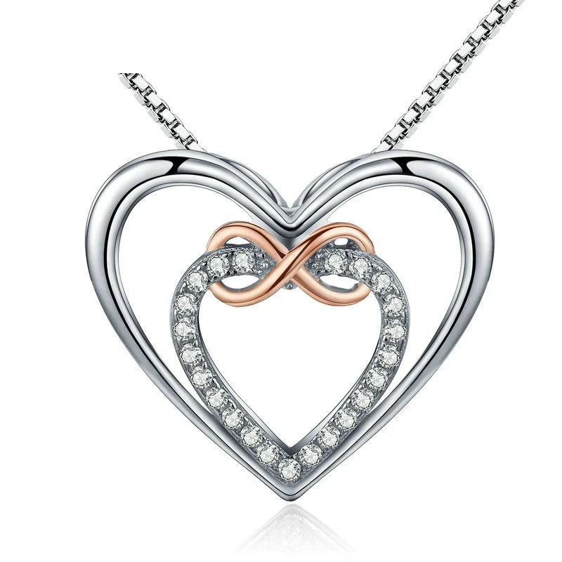 Infinity heart necklace with a polished silver-colored outer heart, CZ inner heart, and rose-gold-colored loop