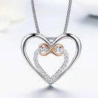 Close-up of the infinity heart pendant with clear CZ stones and a rose-gold-colored loop