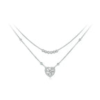 Layered heart necklace in 925 sterling silver with bead strands and a moissanite heart on white