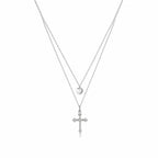Layered Silver Cross Necklace with Heart Pendant on a plain white background
