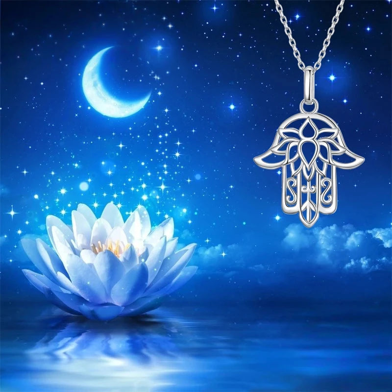 Platinum-plated sterling silver lotus hamsa pendant against a moonlit lotus and starry blue background