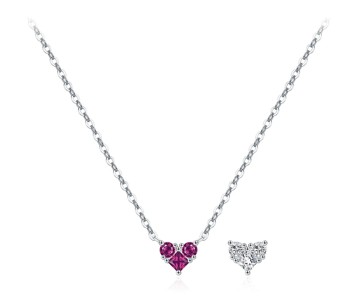 Magenta CZ heart necklace on a fine silver chain beside a clear heart motif
