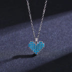 Front view of a turquoise-colored mosaic heart pendant with round light-blue stone rows