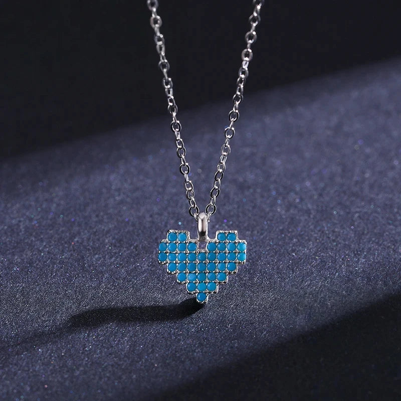 Front view of a turquoise-colored mosaic heart pendant with round light-blue stone rows