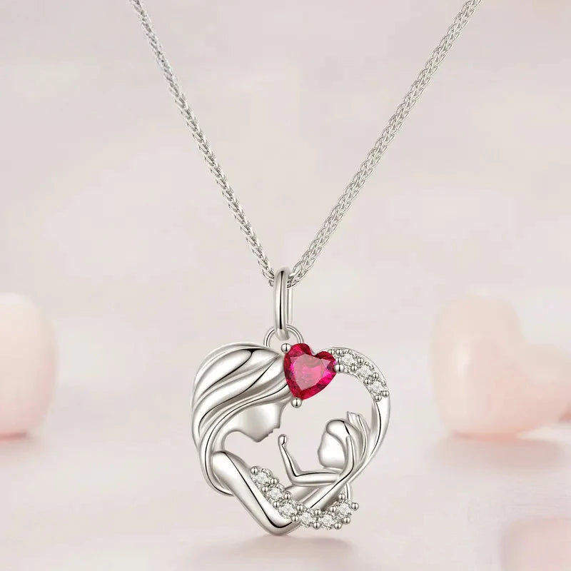 Silver-toned mother and child heart pendant with clear CZ accents and a red heart stone on a chain