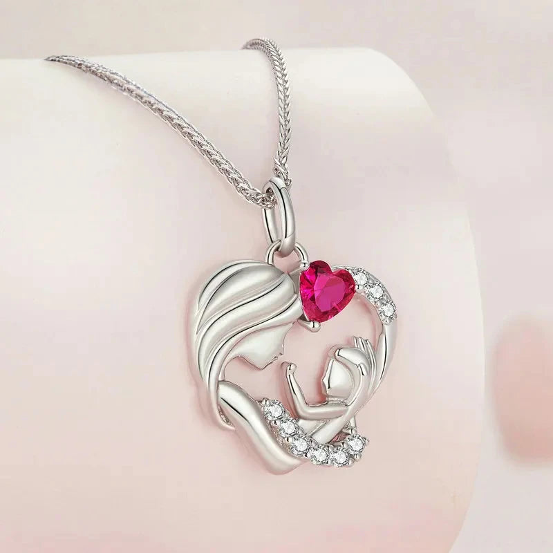 Close-up of the platinum-plated sterling silver heart pendant with mother and child profiles