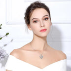 Silver-tone mother daughter heart necklace worn at the base of the neck