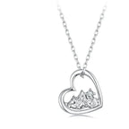 White gold-plated 925 sterling silver heart pendant with raised mountain peaks and a round CZ stone