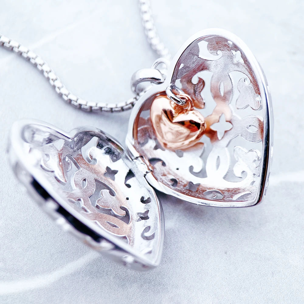 Open 925 sterling silver heart locket showing the rose-gold-colored interior and hinged construction