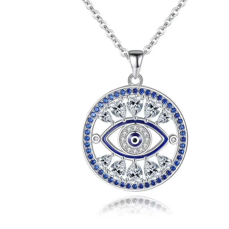 Openwork evil eye necklace with blue and clear cubic zirconia around a round eye pendant on white