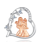Close-up of the openwork heart pendant with rose-gold-colored figures, vine, and heart-shaped CZ stones