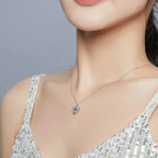 Openwork tree of life heart necklace worn below the collarbone with sparkling CZ stones along the branches