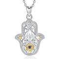 Ornate hamsa hand necklace in 925 sterling silver with a blue eye, lotus, sun and crescent on white