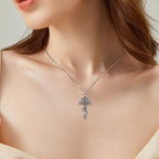 Silver Orthodox crucifix necklace worn on the neck, showing the three-bar cross silhouette