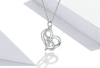 Close-up of overlapping 925 sterling silver hearts with a round center CZ and stone-set curved detail