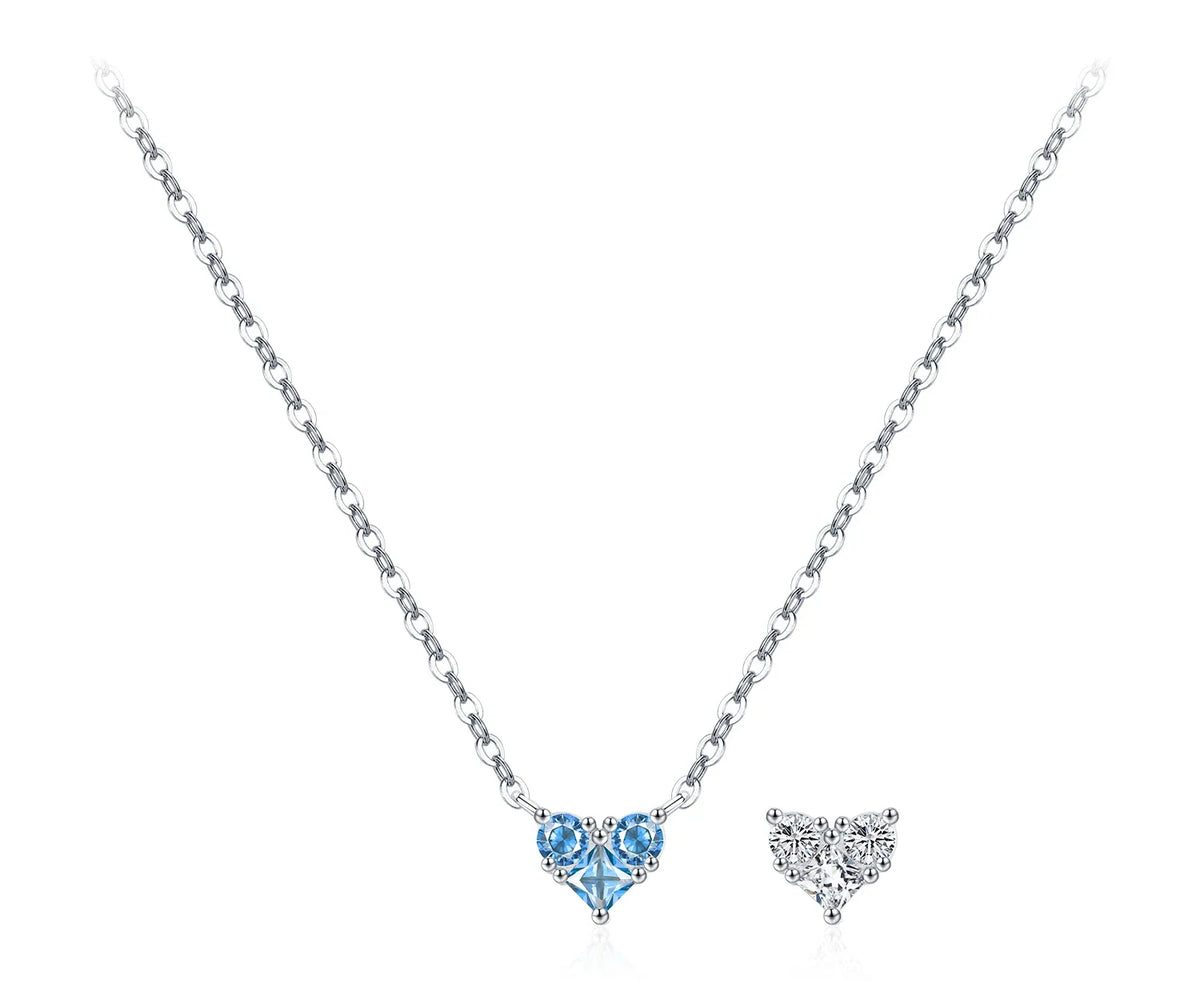 Pale blue CZ heart necklace with round accent stones beside a clear heart motif