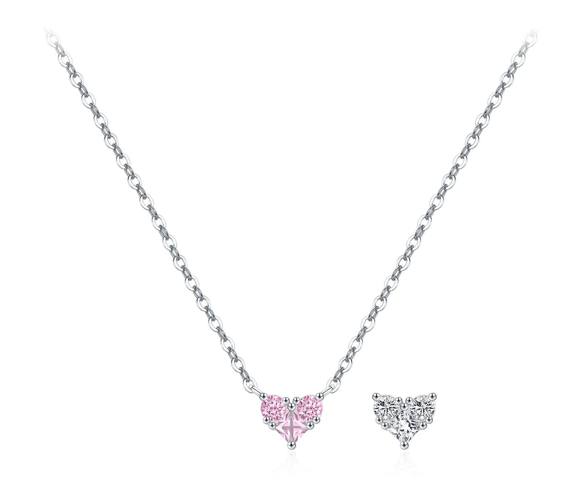 Pale pink CZ heart necklace on a fine silver chain beside a clear heart motif