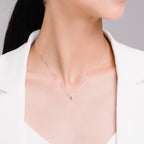 Tiny polished silver heart necklace worn close to the neck on a fine chain