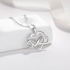 Close-up of a polished 925 sterling silver open heart pendant woven with a sideways infinity loop