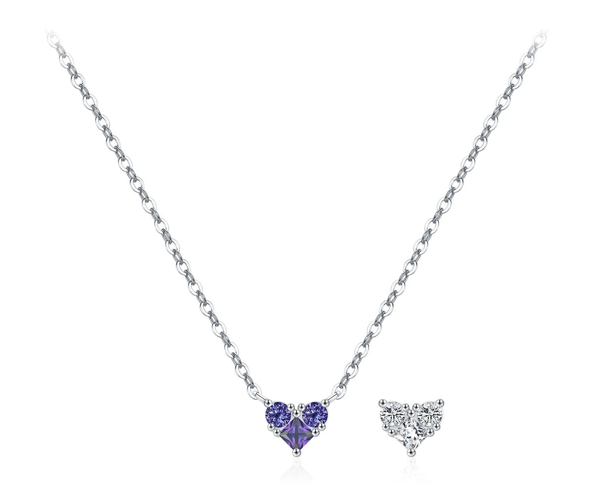 Purple CZ heart necklace on a fine silver chain beside a clear heart motif