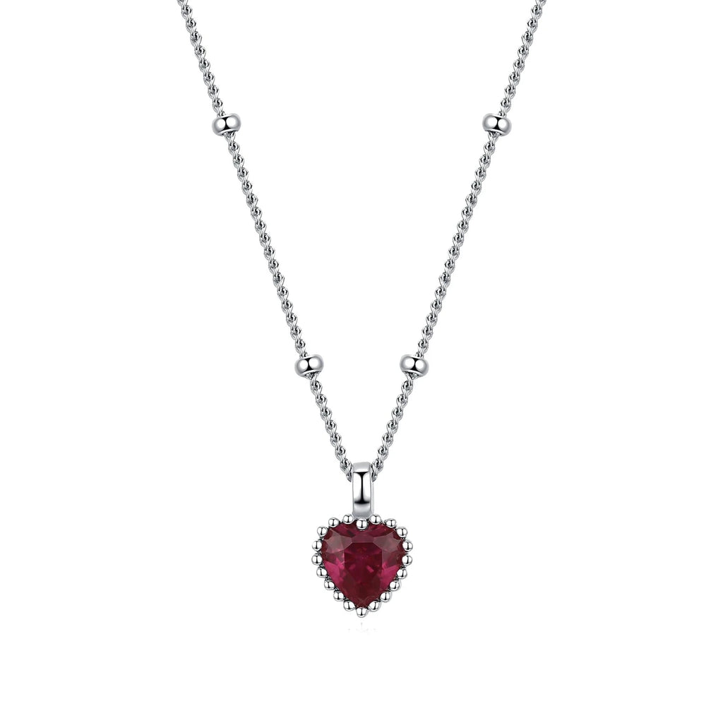 Close-up of the red CZ heart necklace with a scalloped beaded silver-tone frame