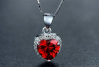 Front close-up of the faceted red CZ heart pendant with a clear CZ halo and polished bail