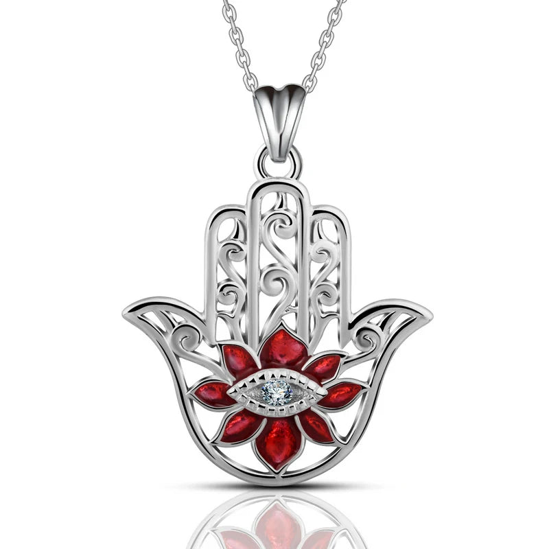 Front view of the red flower hamsa necklace with scrolled openwork and clear stone eye