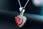 Side close-up of the red CZ heart pendant with clear CZ halo, tapered bail, and box chain