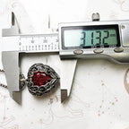 Digital caliper measuring the ornate red heart pendant width at 1.23 in (3.1 cm)