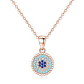Rose gold-tone beaded evil eye necklace with light-blue, clear and dark-blue CZ stone rings on white