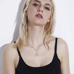 Rose gold Hamsa necklace worn on the neck, showing the Star of David pendant at the collarbone