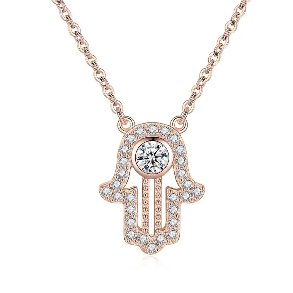 Rose gold-tone hamsa pendant necklace with clear CZ border stones and a larger round center stone