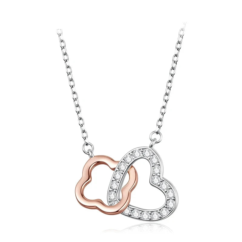 Rose gold heart necklace with a CZ-lined white gold-plated heart on a white background
