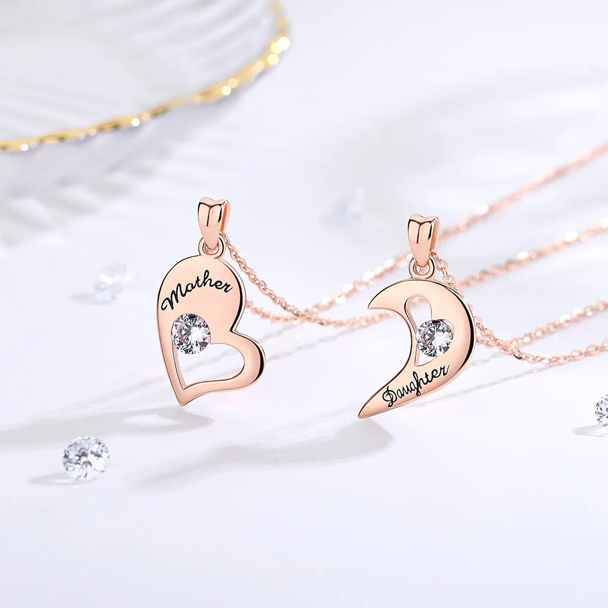 Rose gold-tone open heart and crescent pendants with black Mother and Daughter lettering