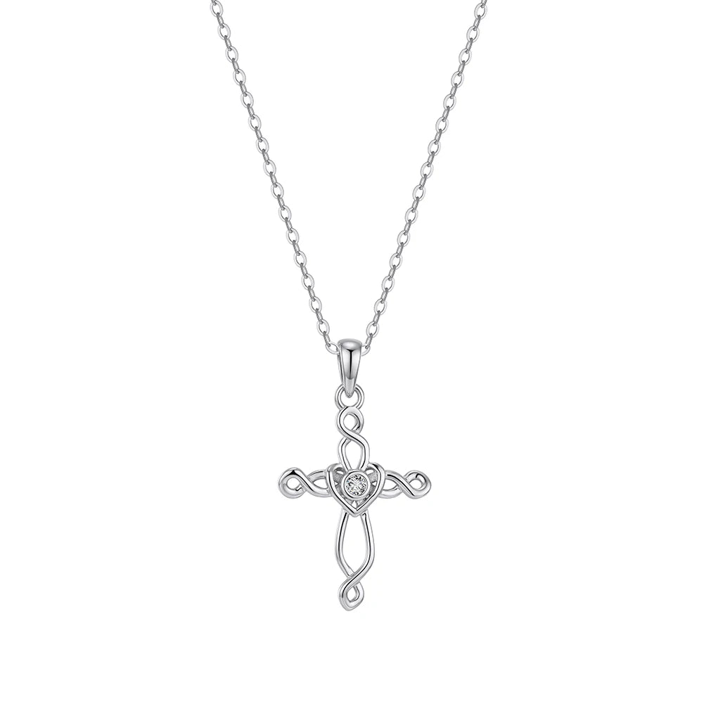 Silver-tone Celtic cross necklace on white with an interlaced openwork design and heart center stone