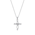 Silver-tone Celtic cross necklace on white with an interlaced openwork design and heart center stone