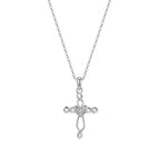Silver-tone Celtic cross necklace on white with an interlaced openwork design and heart center stone