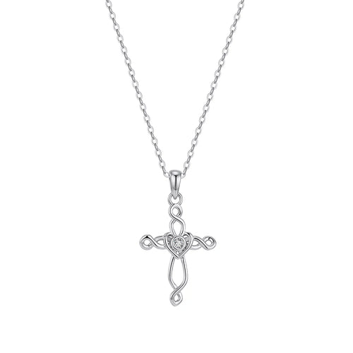 Silver-tone Celtic cross necklace on white with an interlaced openwork design and heart center stone