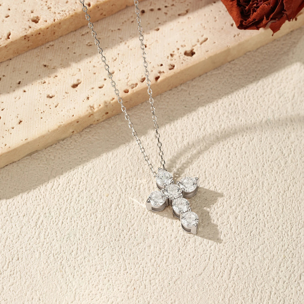 Angled view of the 925 sterling silver cross necklace showing the prong-held moissanite stone settings