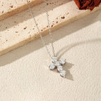 Angled view of the 925 sterling silver cross necklace showing the prong-held moissanite stone settings
