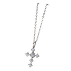 Silver-tone cross necklace with six clear cubic zirconia stones and a larger center stone on a white background
