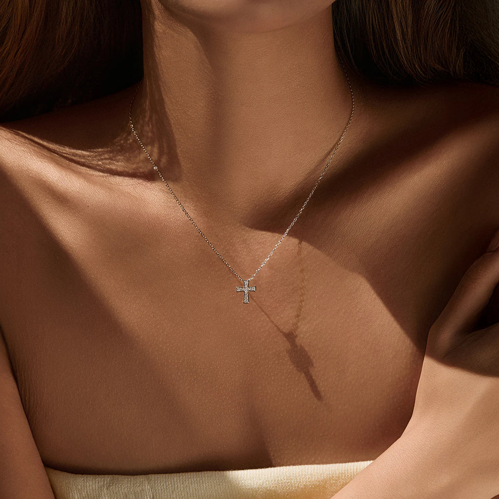 Small 925 sterling silver cross necklace with moissanite stones worn at the collarbone