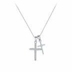 Double silver cross necklace with a CZ-lined cross and smaller center-stone cross on white
