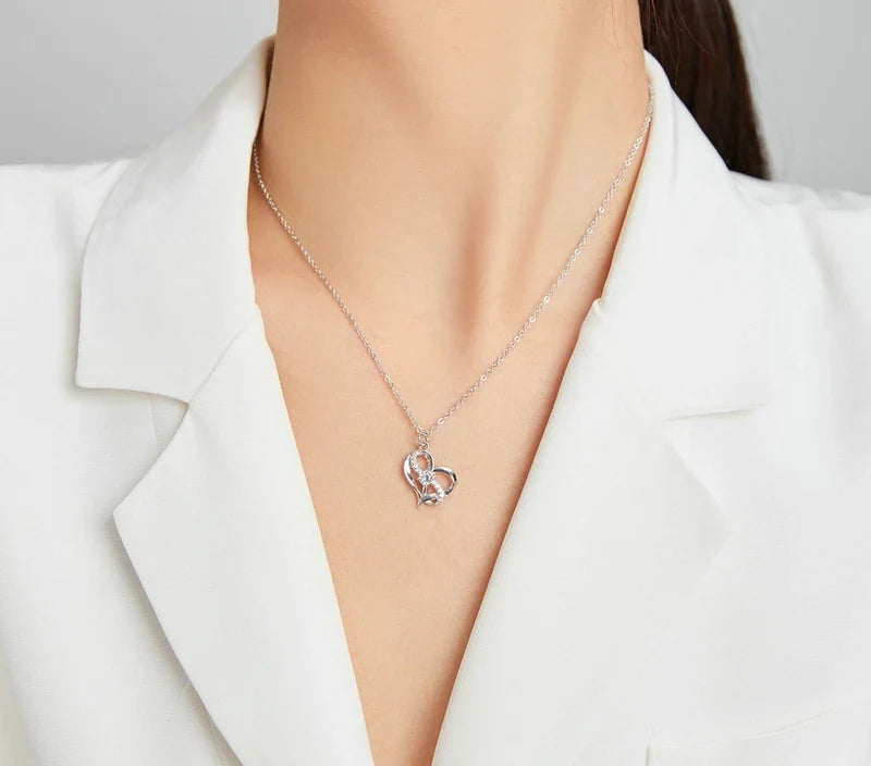 Platinum-plated sterling silver double heart pendant with clear CZ stones worn below the collarbone