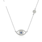 Horizontal evil eye necklace with blue CZ center, clear CZ outline, and round chain station on white