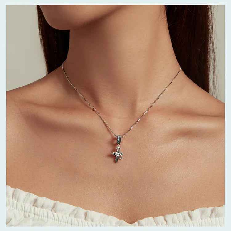 Fine box chain worn with a 925 sterling silver Eye of Horus ankh pendant and blue CZ details