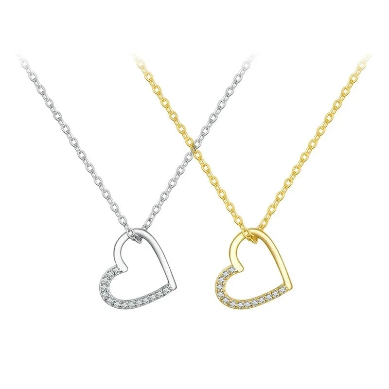 Asymmetrical open heart necklaces in silver-tone and gold-tone with clear CZ stone-set lower curves
