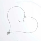 Silver-tone hamsa necklace laid open on white, showing the chain, extender, clasp, and small pendant