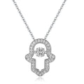 Silver-tone open hamsa necklace close-up with clear CZ stones framing the open hand and center stone